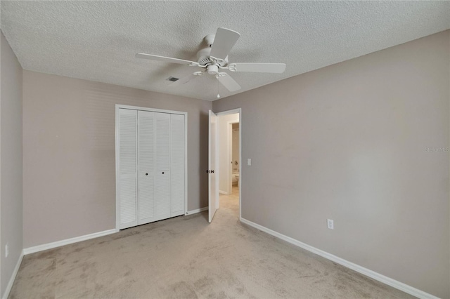 2527 Wrencrest Cir, Valrico, FL 33594 - unfurnished bedroom with a closet, carpet flooring, baseboards, a textured ceiling, and a ceiling fan