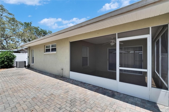 2527 Wrencrest Cir, Valrico, FL 33594 - view of property exterior with central AC unit, ceiling fan, a sunroom, a patio, and stucco siding