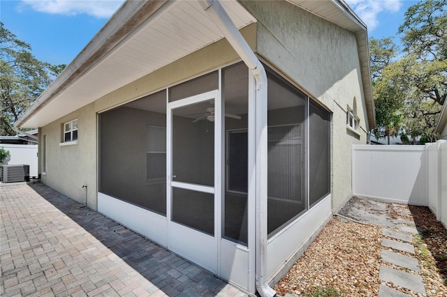 2527 Wrencrest Cir, Valrico, FL 33594 - view of side of home featuring a sunroom, stucco siding, and cooling unit