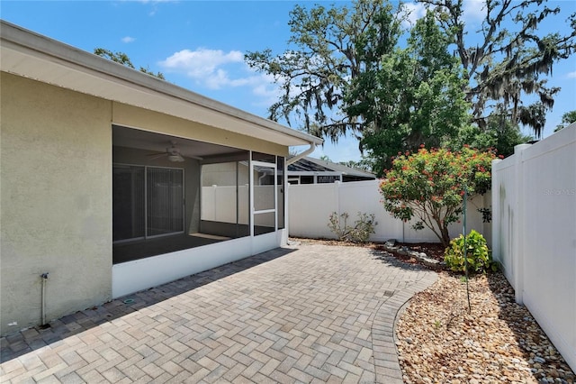 2527 Wrencrest Cir, Valrico, FL 33594 - fenced backyard with a sunroom, a ceiling fan, and a patio area