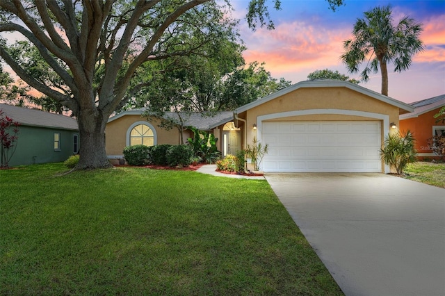 11510 92nd Way, Largo, FL 33773 - ranch-style house with stucco siding, concrete driveway, an attached garage, and a lawn