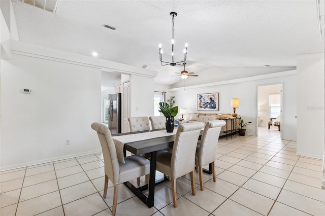 11510 92nd Way, Largo, FL 33773 - dining area featuring a chandelier, vaulted ceiling, light tile patterned floors, a ceiling fan, and baseboards