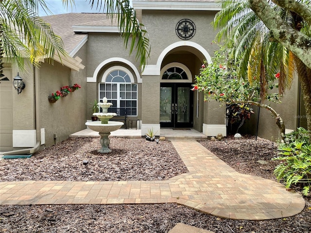 4808 Jewell Ter, Palm Harbor, FL 34685 - entrance to property featuring french doors, stucco siding, and roof with shingles