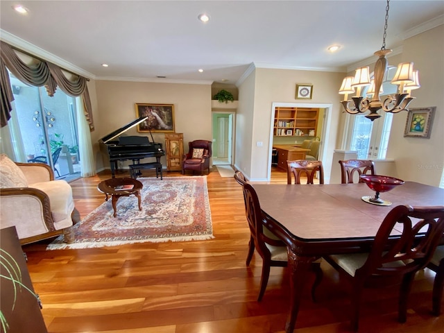 4808 Jewell Ter, Palm Harbor, FL 34685 - dining room featuring a chandelier, healthy amount of natural light, wood finished floors, crown molding, and recessed lighting