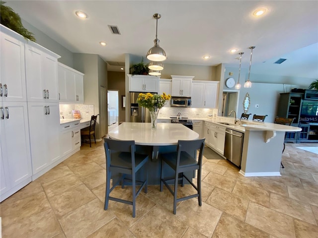 4808 Jewell Ter, Palm Harbor, FL 34685 - kitchen featuring appliances with stainless steel finishes, a peninsula, a sink, backsplash, and recessed lighting