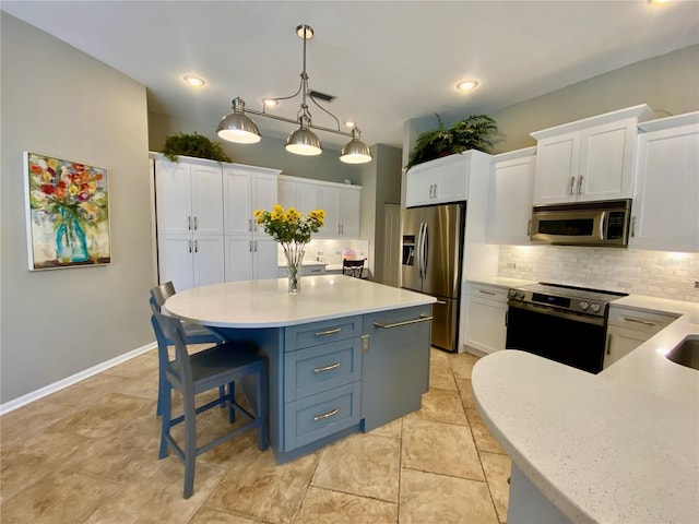 4808 Jewell Ter, Palm Harbor, FL 34685 - kitchen with stainless steel appliances, light countertops, white cabinetry, tasteful backsplash, and recessed lighting