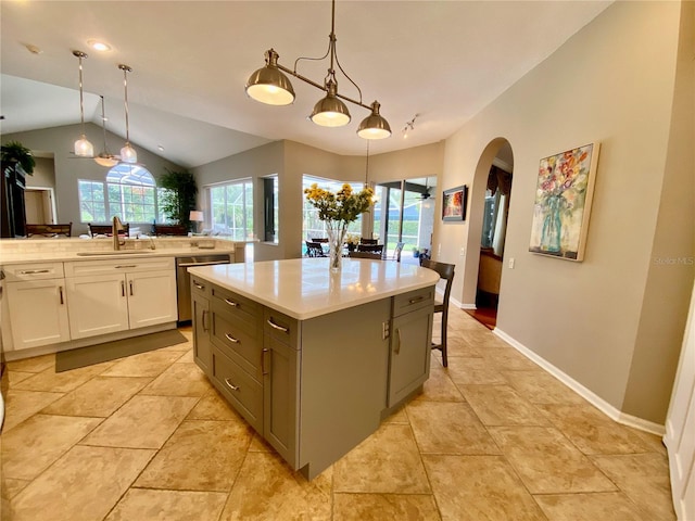 4808 Jewell Ter, Palm Harbor, FL 34685 - kitchen featuring a sink, dishwasher, lofted ceiling, a kitchen island, and light countertops