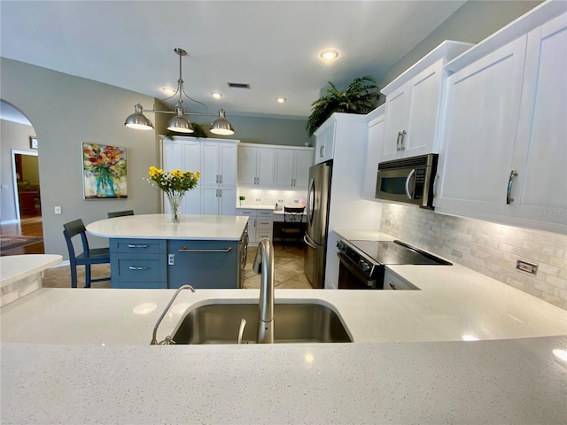 4808 Jewell Ter, Palm Harbor, FL 34685 - kitchen featuring appliances with stainless steel finishes, a sink, backsplash, white cabinets, and recessed lighting