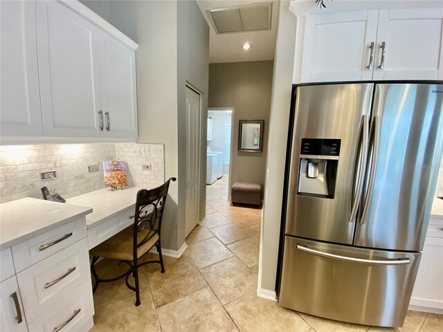 4808 Jewell Ter, Palm Harbor, FL 34685 - kitchen featuring stainless steel fridge, tasteful backsplash, white cabinets, and light countertops