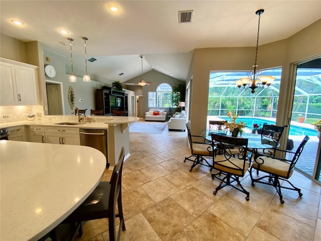 4808 Jewell Ter, Palm Harbor, FL 34685 - dining area featuring vaulted ceiling, light stone finish flooring, recessed lighting, a chandelier, and a ceiling fan