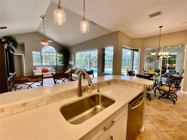 4808 Jewell Ter, Palm Harbor, FL 34685 - kitchen featuring a sink, hanging light fixtures, light stone countertops, dishwasher, and lofted ceiling