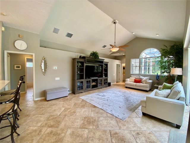 4808 Jewell Ter, Palm Harbor, FL 34685 - living area featuring a ceiling fan, lofted ceiling, baseboards, and light stone finish floors