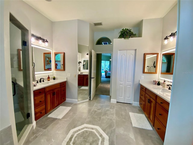 4808 Jewell Ter, Palm Harbor, FL 34685 - bathroom featuring two vanities, a shower stall, a towering ceiling, and baseboards