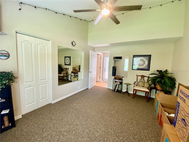 4808 Jewell Ter, Palm Harbor, FL 34685 - sitting room with carpet flooring, ceiling fan, a high ceiling, and baseboards