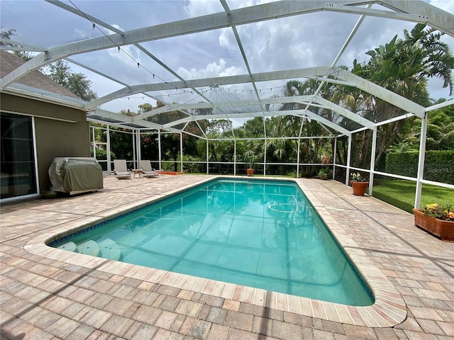 4808 Jewell Ter, Palm Harbor, FL 34685 - swimming pool featuring area for grilling, a patio area, and glass enclosure