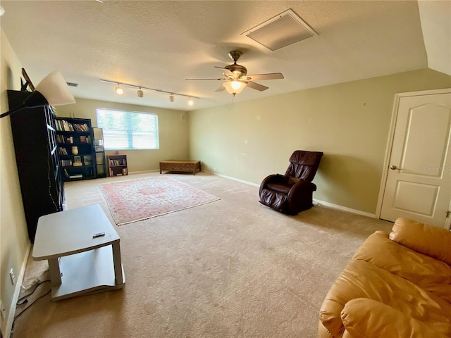 4808 Jewell Ter, Palm Harbor, FL 34685 - sitting room featuring carpet flooring, a ceiling fan, a textured ceiling, track lighting, and baseboards