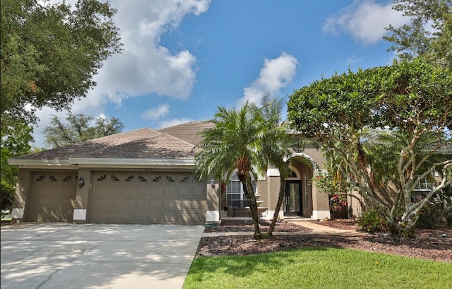 4808 Jewell Ter, Palm Harbor, FL 34685 - view of front of home featuring an attached garage, stucco siding, and concrete driveway