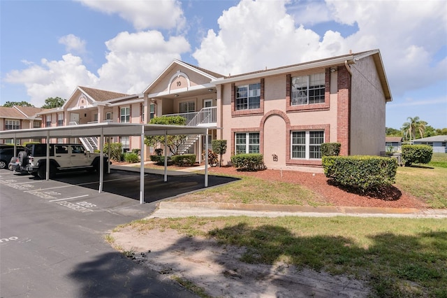 6334 Spring Flower Dr Unit 24, New Port Richey, FL 34653 - view of front of property featuring stairway and covered parking