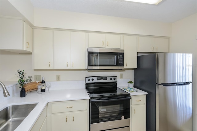 6334 Spring Flower Dr Unit 24, New Port Richey, FL 34653 - kitchen featuring appliances with stainless steel finishes, a sink, light countertops, and white cabinets
