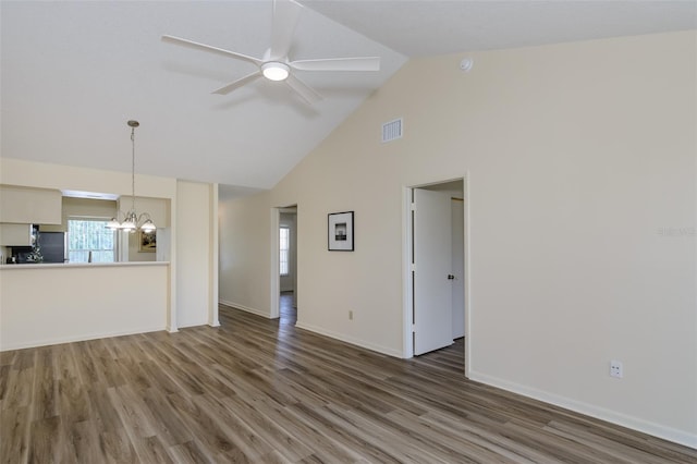 6334 Spring Flower Dr Unit 24, New Port Richey, FL 34653 - unfurnished living room featuring a chandelier, high vaulted ceiling, wood finished floors, ceiling fan, and baseboards
