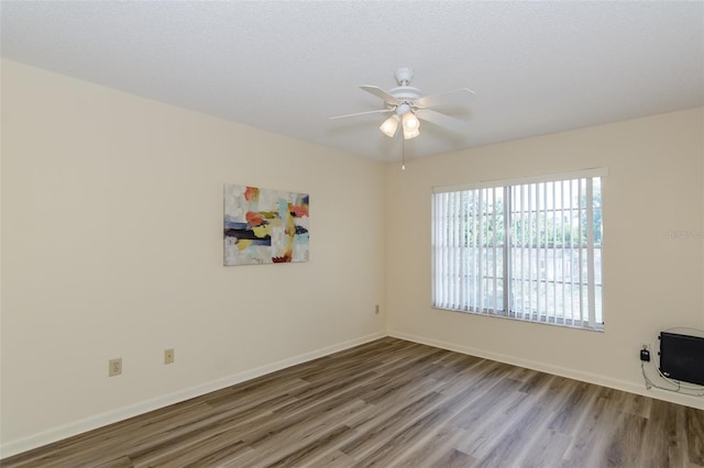 6334 Spring Flower Dr Unit 24, New Port Richey, FL 34653 - spare room featuring wood finished floors, ceiling fan, and baseboards
