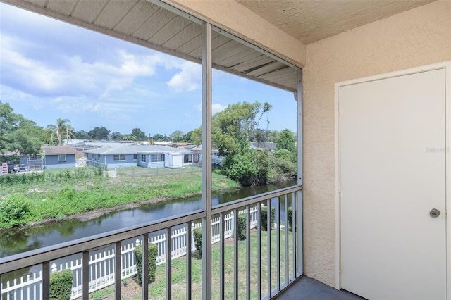 6334 Spring Flower Dr Unit 24, New Port Richey, FL 34653 - balcony featuring a water view and a residential view