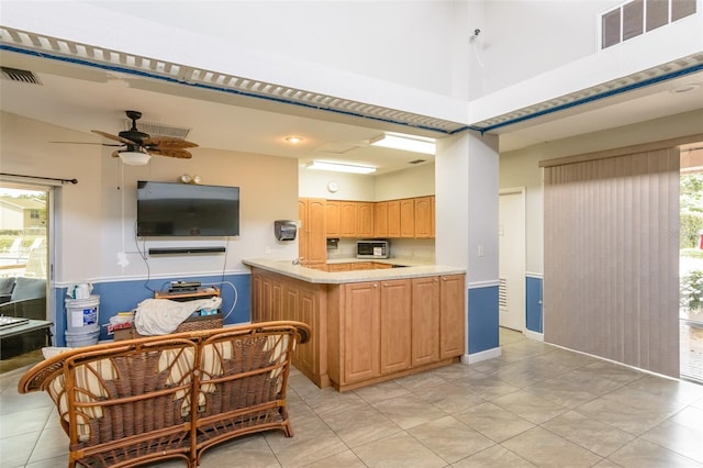 6334 Spring Flower Dr Unit 24, New Port Richey, FL 34653 - kitchen featuring a ceiling fan, light countertops, light tile patterned floors, light brown cabinetry, and a high ceiling