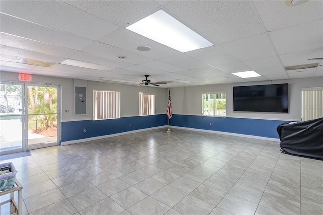 6334 Spring Flower Dr Unit 24, New Port Richey, FL 34653 - spare room featuring baseboards, a drop ceiling, a ceiling fan, light tile patterned floors, and electric panel