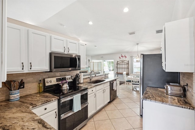 6724 Clair Shore Dr, Apollo Beach, FL 33572 - kitchen with appliances with stainless steel finishes, a sink, white cabinets, decorative backsplash, and recessed lighting