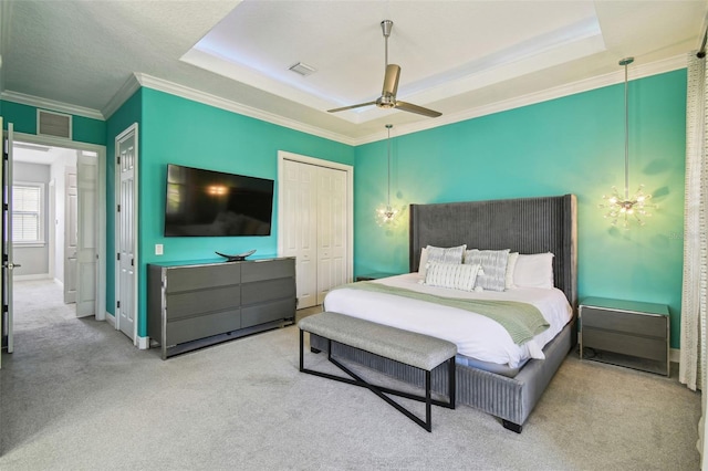 7523 Excitement Dr, Kissimmee, FL 34747 - bedroom featuring crown molding, carpet floors, a closet, a tray ceiling, and ceiling fan