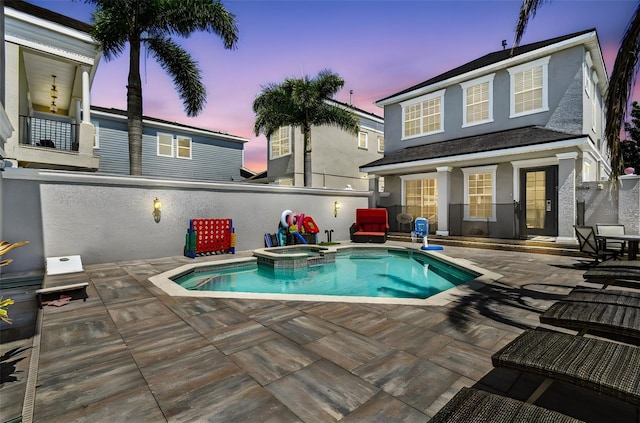 7523 Excitement Dr, Kissimmee, FL 34747 - pool at dusk featuring a patio and a pool with connected hot tub