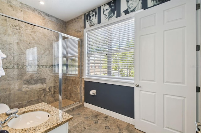 7523 Excitement Dr, Kissimmee, FL 34747 - full bathroom featuring a shower stall, baseboards, and vanity