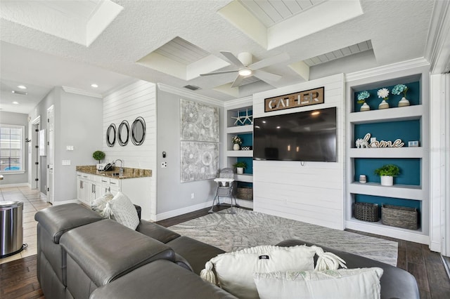 7523 Excitement Dr, Kissimmee, FL 34747 - living area featuring baseboards, wood finished floors, ornamental molding, a ceiling fan, and built in features