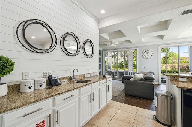 7523 Excitement Dr, Kissimmee, FL 34747 - kitchen with crown molding, a sink, open floor plan, white cabinets, and coffered ceiling