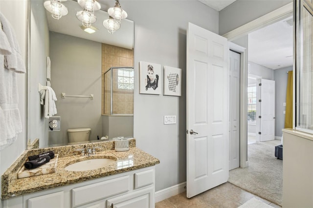 7523 Excitement Dr, Kissimmee, FL 34747 - full bathroom featuring baseboards, vanity, tile patterned floors, toilet, and tiled shower