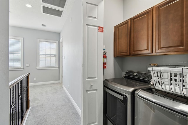 7523 Excitement Dr, Kissimmee, FL 34747 - laundry room featuring cabinet space, light colored carpet, washer and clothes dryer, and baseboards