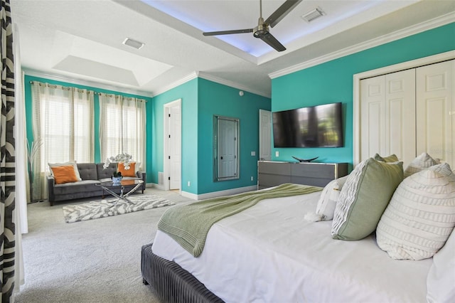 7523 Excitement Dr, Kissimmee, FL 34747 - carpeted bedroom with ornamental molding, baseboards, a tray ceiling, a ceiling fan, and a closet