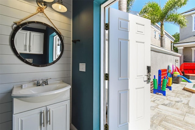 7523 Excitement Dr, Kissimmee, FL 34747 - bathroom featuring vanity and wooden walls