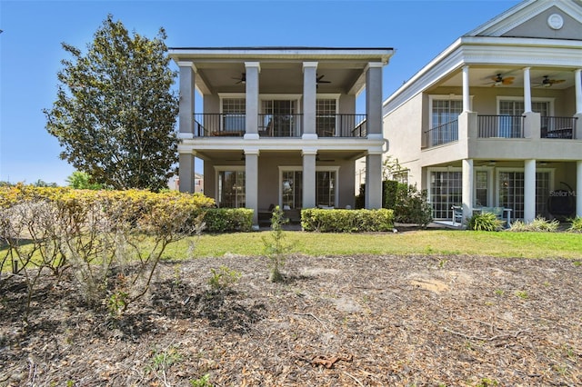 7523 Excitement Dr, Kissimmee, FL 34747 - neoclassical home featuring ceiling fan, a balcony, and stucco siding