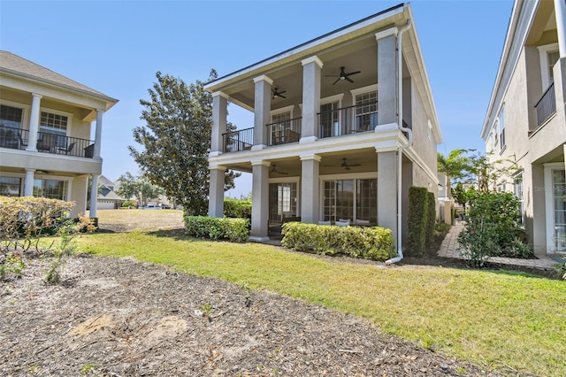 7523 Excitement Dr, Kissimmee, FL 34747 - view of front of property with a ceiling fan, a balcony, a front lawn, and stucco siding