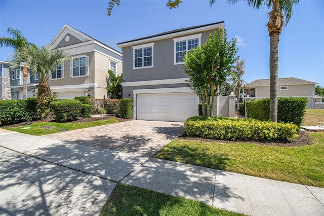 7523 Excitement Dr, Kissimmee, FL 34747 - traditional home with a garage, stucco siding, and driveway
