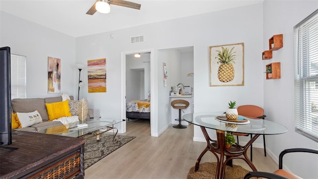 1615 28th Ave N, Saint Petersburg, FL 33713 - living area featuring light wood finished floors, ceiling fan, and baseboards