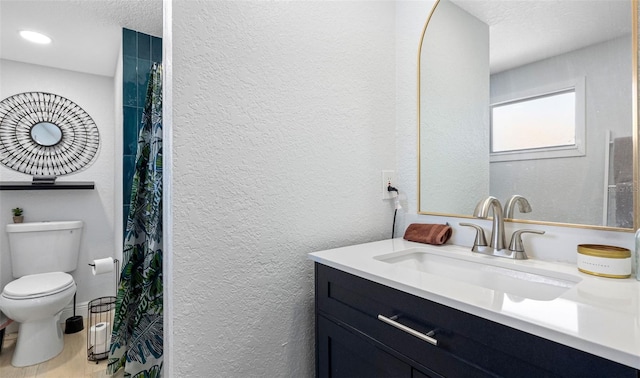1615 28th Ave N, Saint Petersburg, FL 33713 - full bathroom with toilet, a textured wall, and vanity