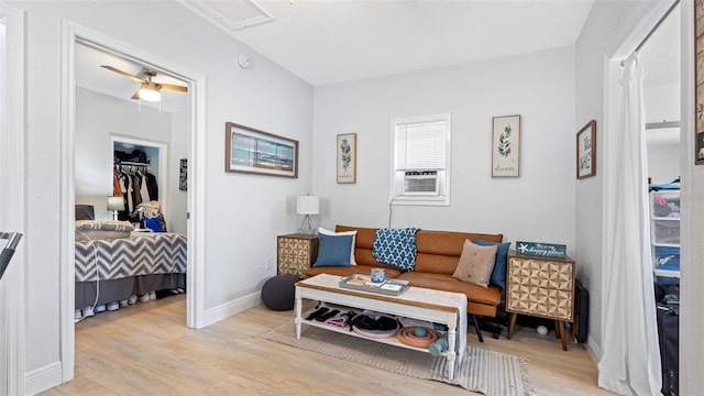 1615 28th Ave N, Saint Petersburg, FL 33713 - living room with light wood finished floors, cooling unit, baseboards, and a ceiling fan