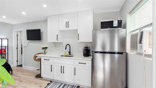 1615 28th Ave N, Saint Petersburg, FL 33713 - kitchen with stainless steel appliances, a sink, white cabinetry, baseboards, and recessed lighting