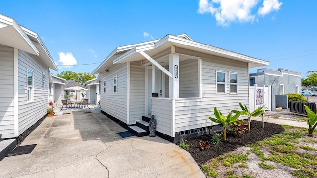 1615 28th Ave N, Saint Petersburg, FL 33713 - view of side of home with outdoor dining area and a patio area