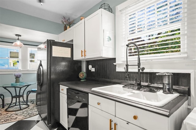 634 6th St N, Saint Petersburg, FL 33701 - kitchen featuring black appliances, a sink, white cabinetry, dark countertops, and decorative backsplash