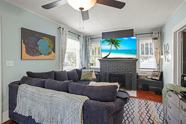 634 6th St N, Saint Petersburg, FL 33701 - living area featuring ornamental molding, ceiling fan, wood finished floors, and a brick fireplace