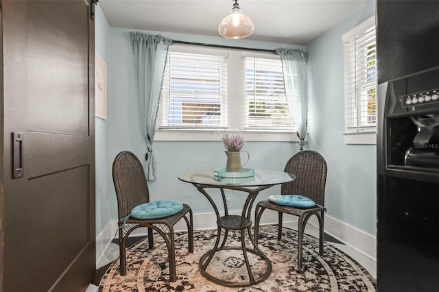 634 6th St N, Saint Petersburg, FL 33701 - dining area with baseboards and a barn door