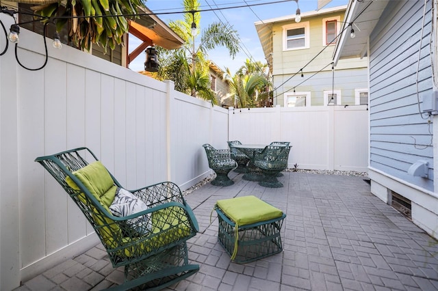634 6th St N, Saint Petersburg, FL 33701 - fenced backyard featuring a patio and outdoor dining space